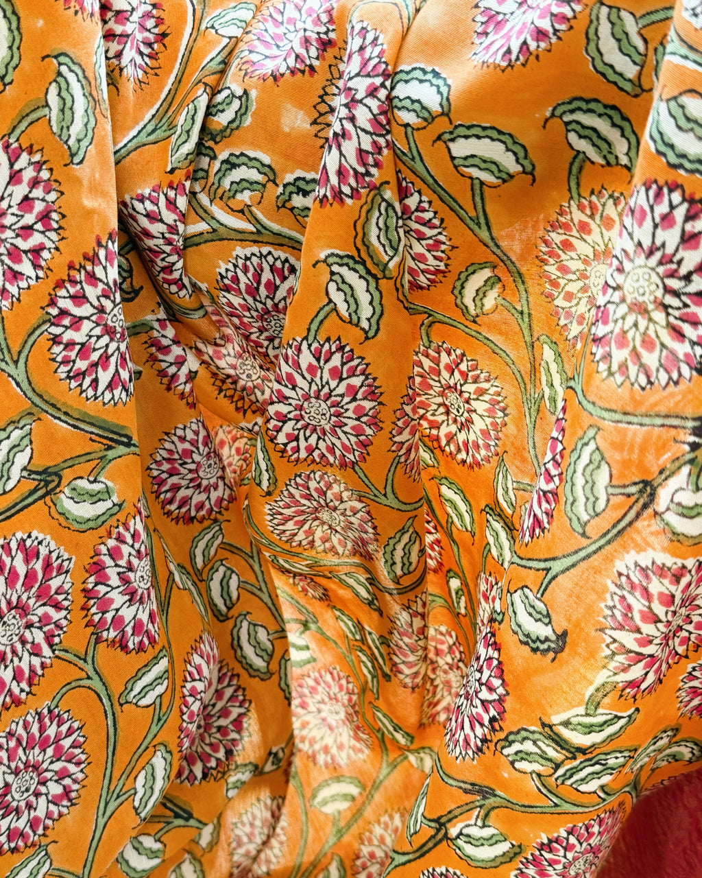 close up sanganeri floral print orange modal silk saree