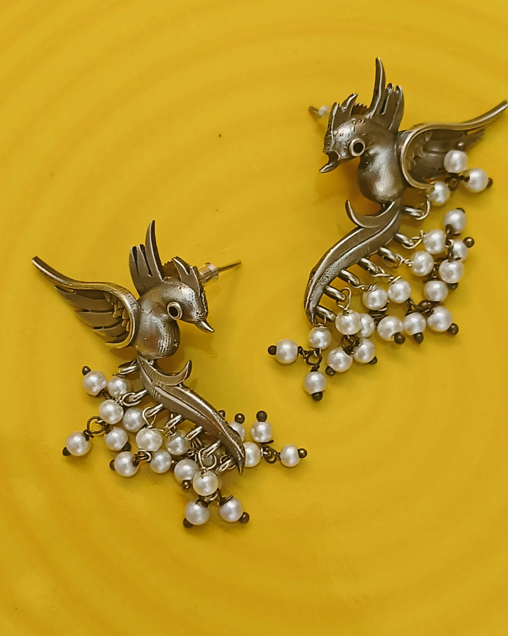 Oxidised bird earrings with pearl drop clusters and curved design