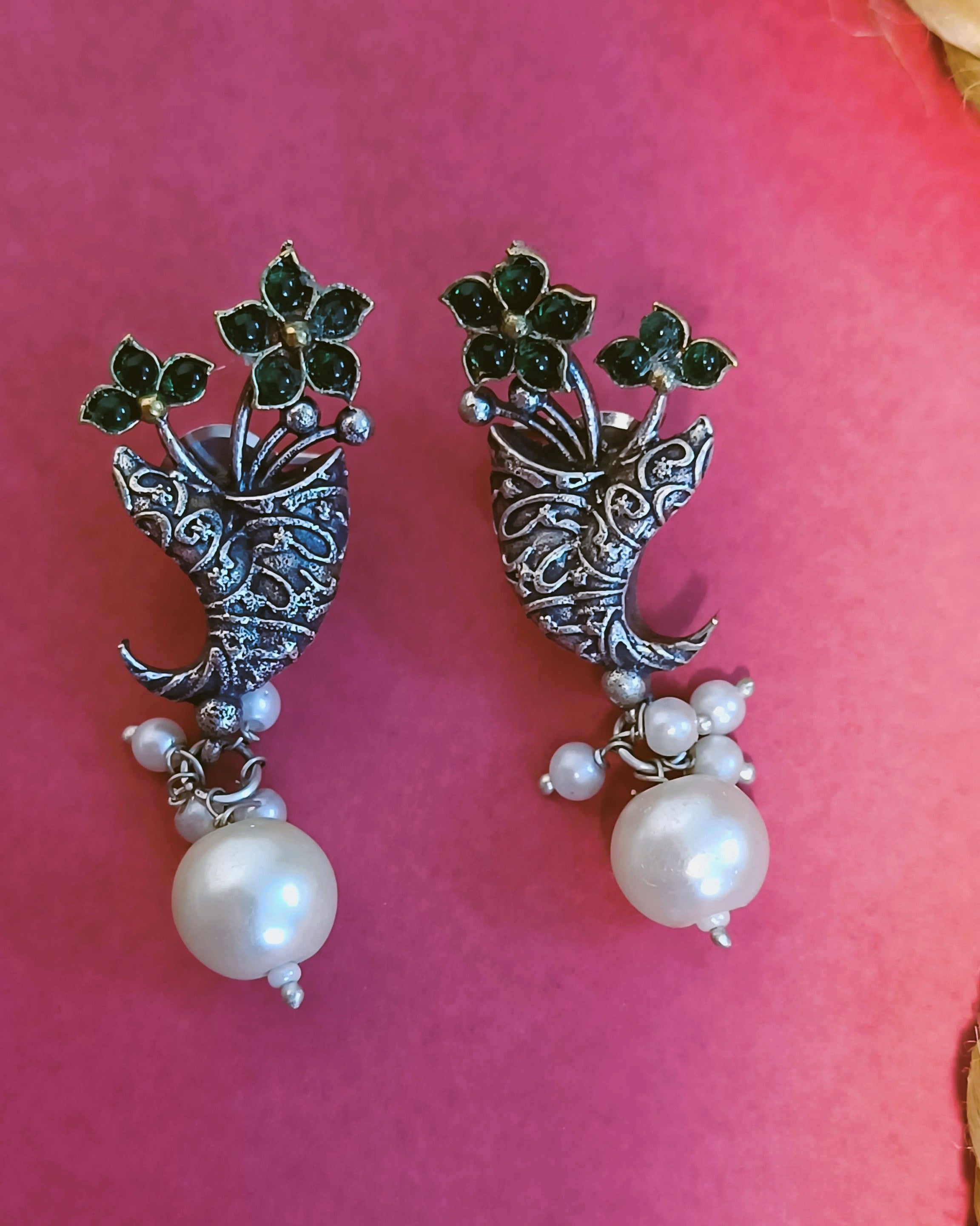 Oxidised silver peacock stud earrings with emerald-green stone accents and single white pearl drop