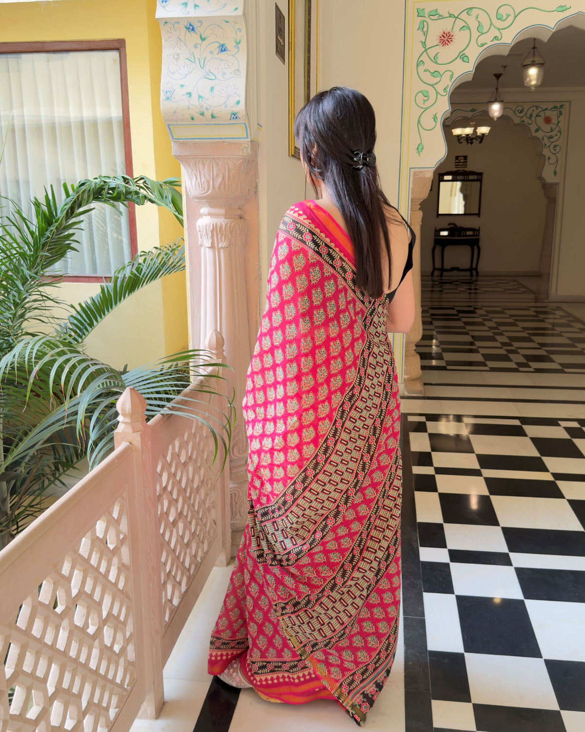 Woman wearing pink and black leaf motifs zari cotton saree, draped look for festive and daily wear