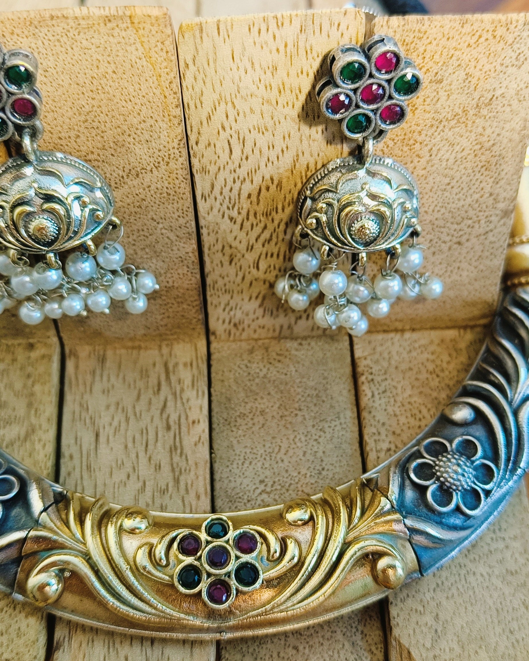 Rajwada dual tone choker necklace and jhumka earrings set styled with bridal ethnic wear showcasing gold and oxidised silver finish