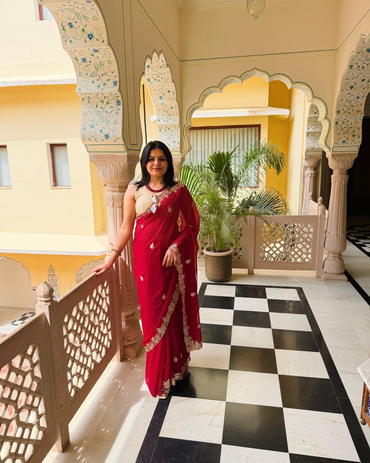 Rani red georgette saree featuring floral and leaf Gotta work motifs