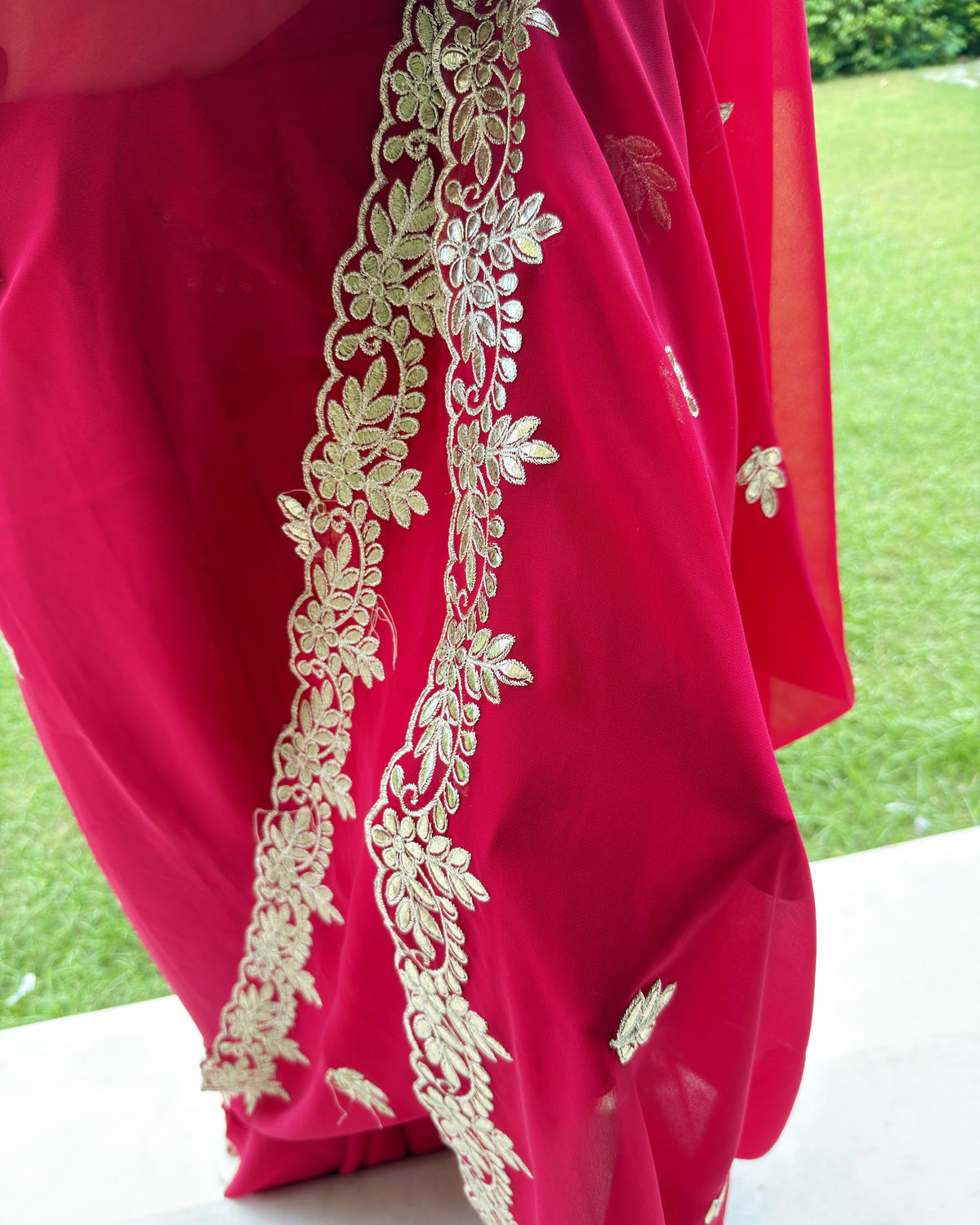 Close-up of intricate Gotta Patti Pitten work on Rani red saree