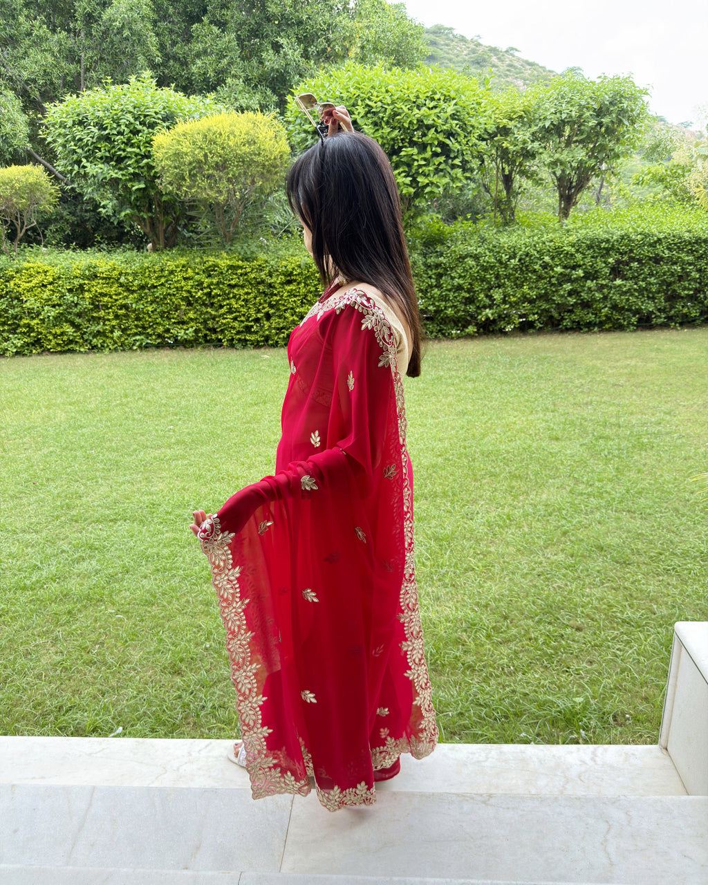 Detailed floral Gotta Patti border on Rani red georgette saree