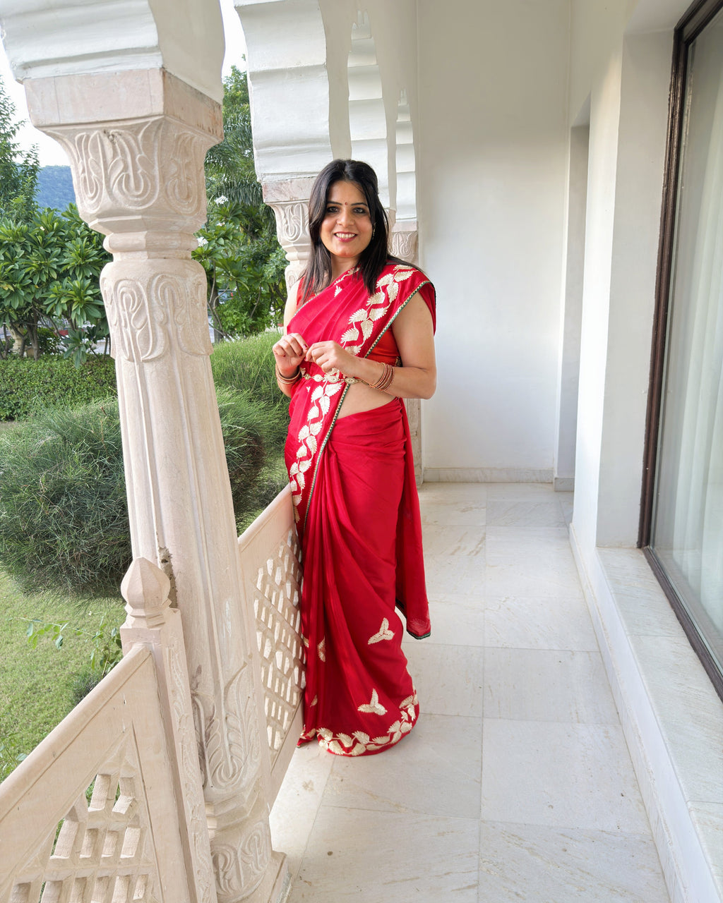 Red Chinnon Silk saree with intricate Gotta Patti work and floral border