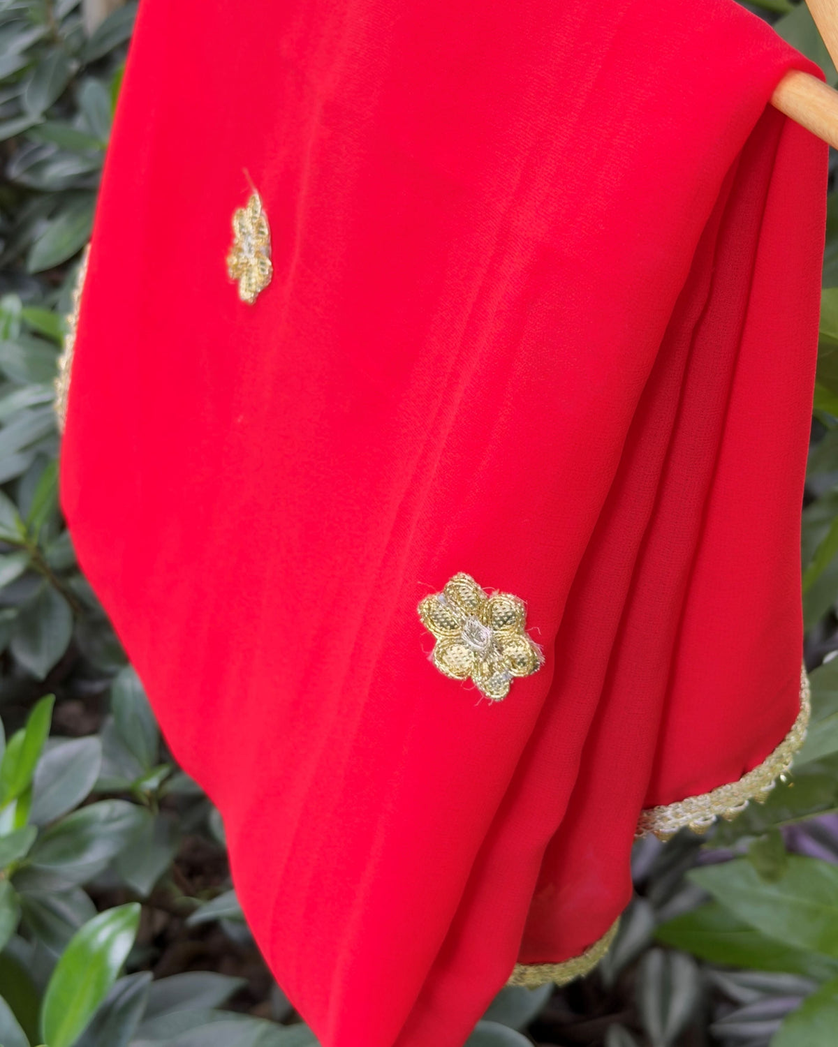 Close-up of floral embellishment on red georgette dupatta