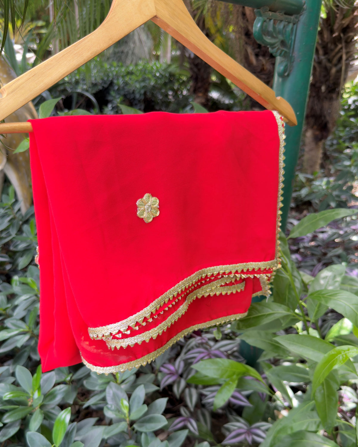 Close-up of gold decorative border on red georgette dupatta