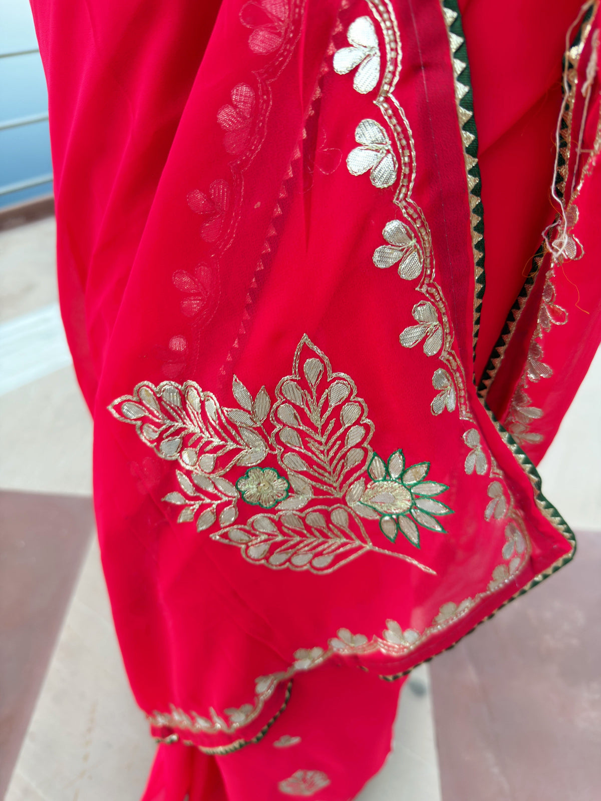 Red Georgette saree with intricate floral and leaf motifs