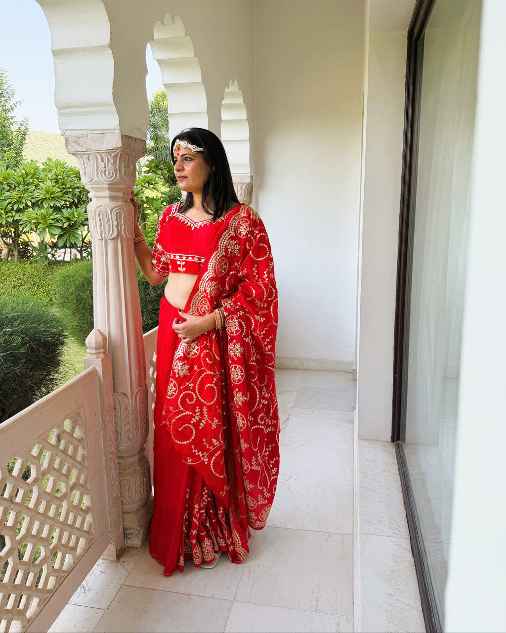 Red saree featuring intricate floral Gotta Patti motifs