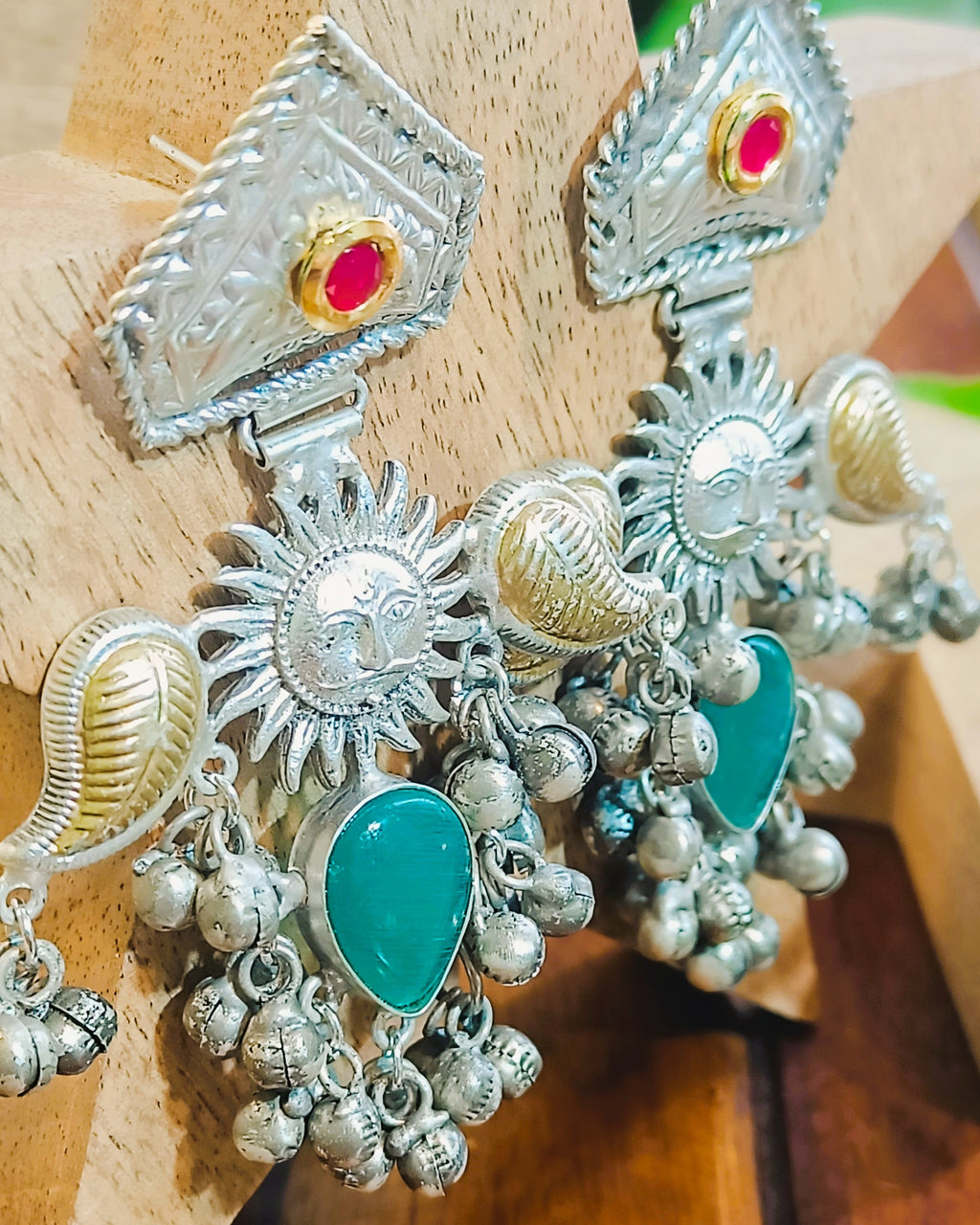 Close-up of Surya Kiran brass earrings with intricate sun design