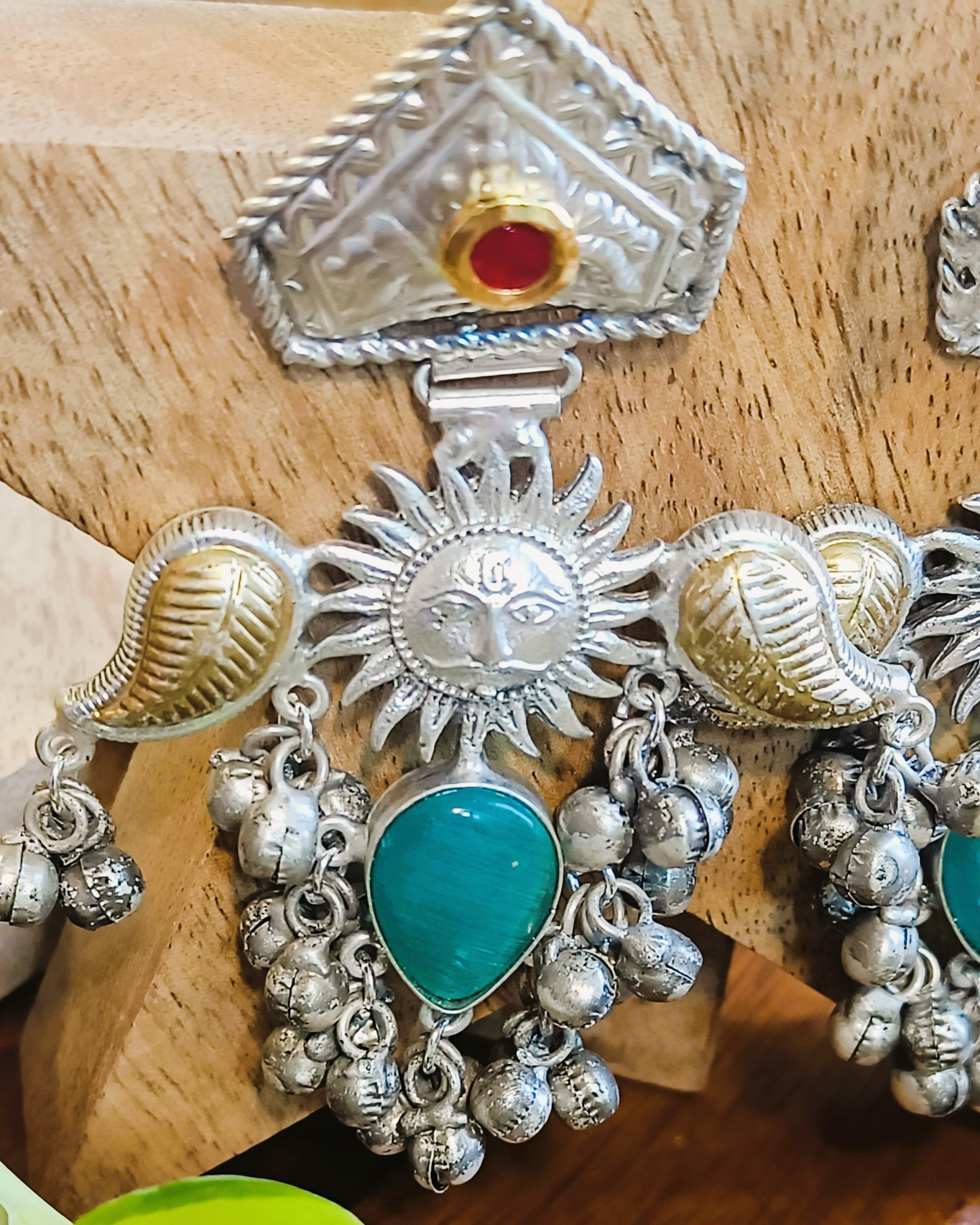 Detailed view of Surya Kiran earrings with antique brass finish