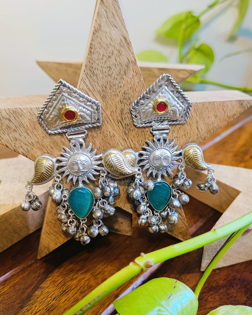 Surya Kiran brass earrings with sun motif and green stone detail