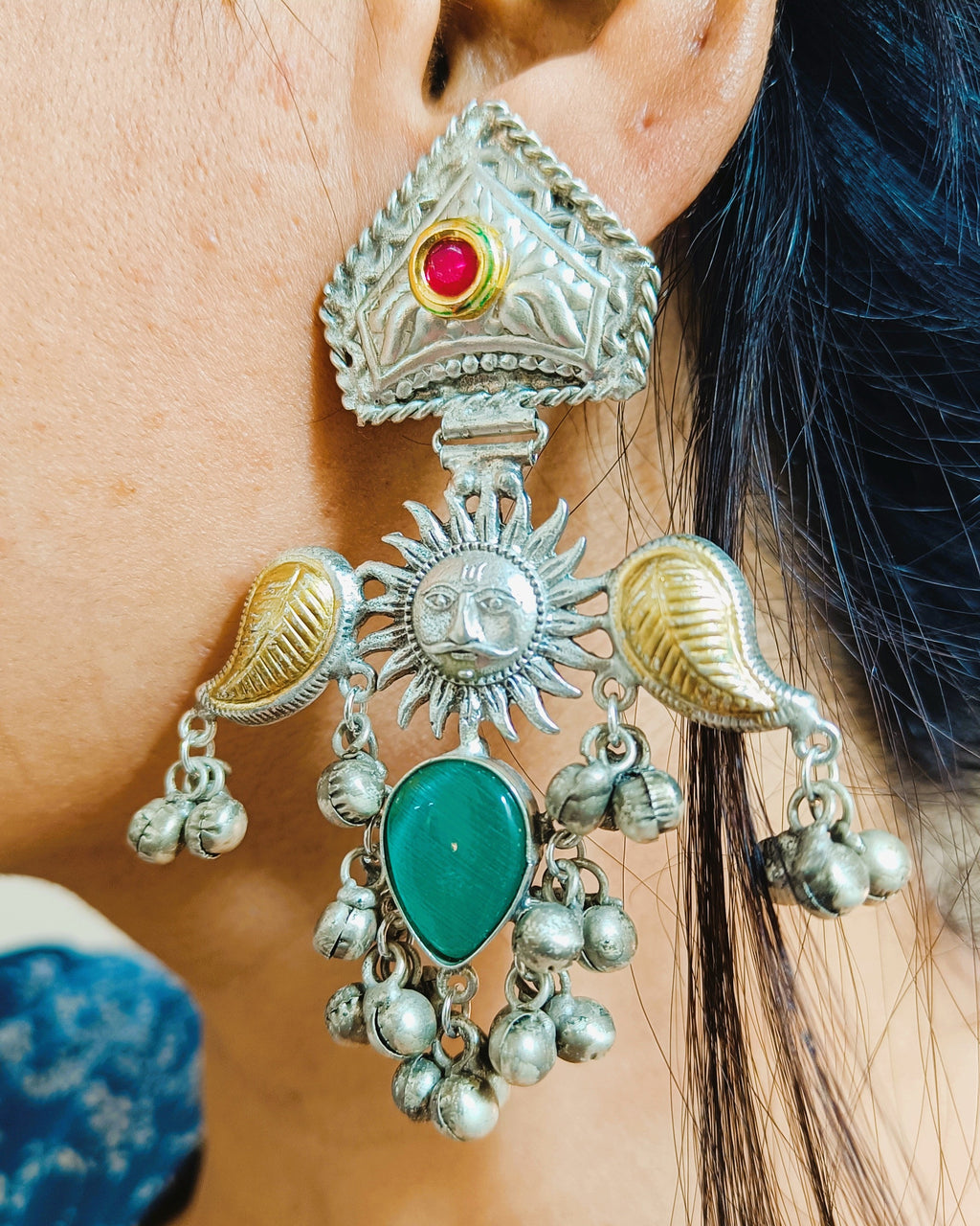 Surya Kiran brass earrings styled on ear with traditional look