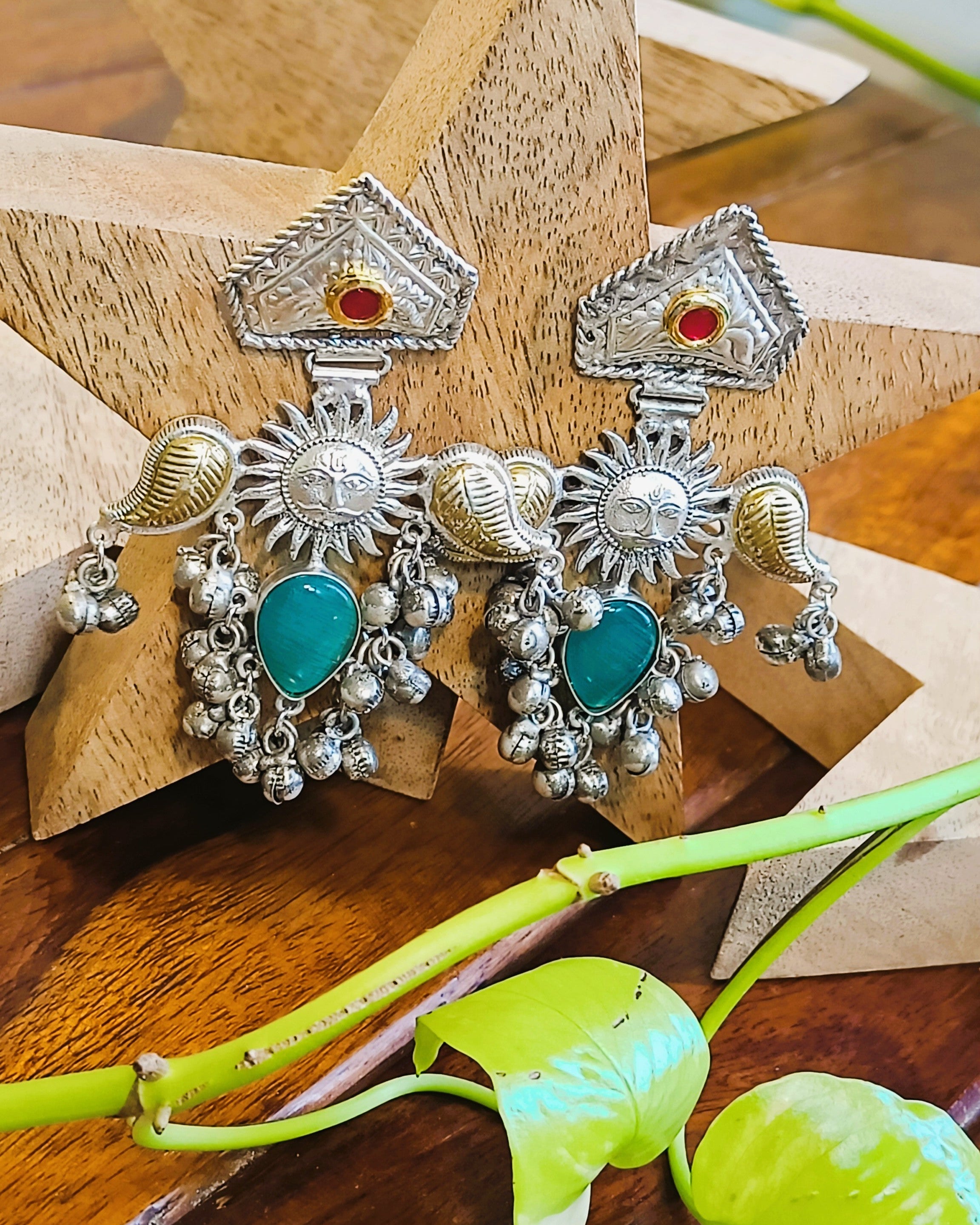 Side view of Surya Kiran brass earrings with ghungroo drops