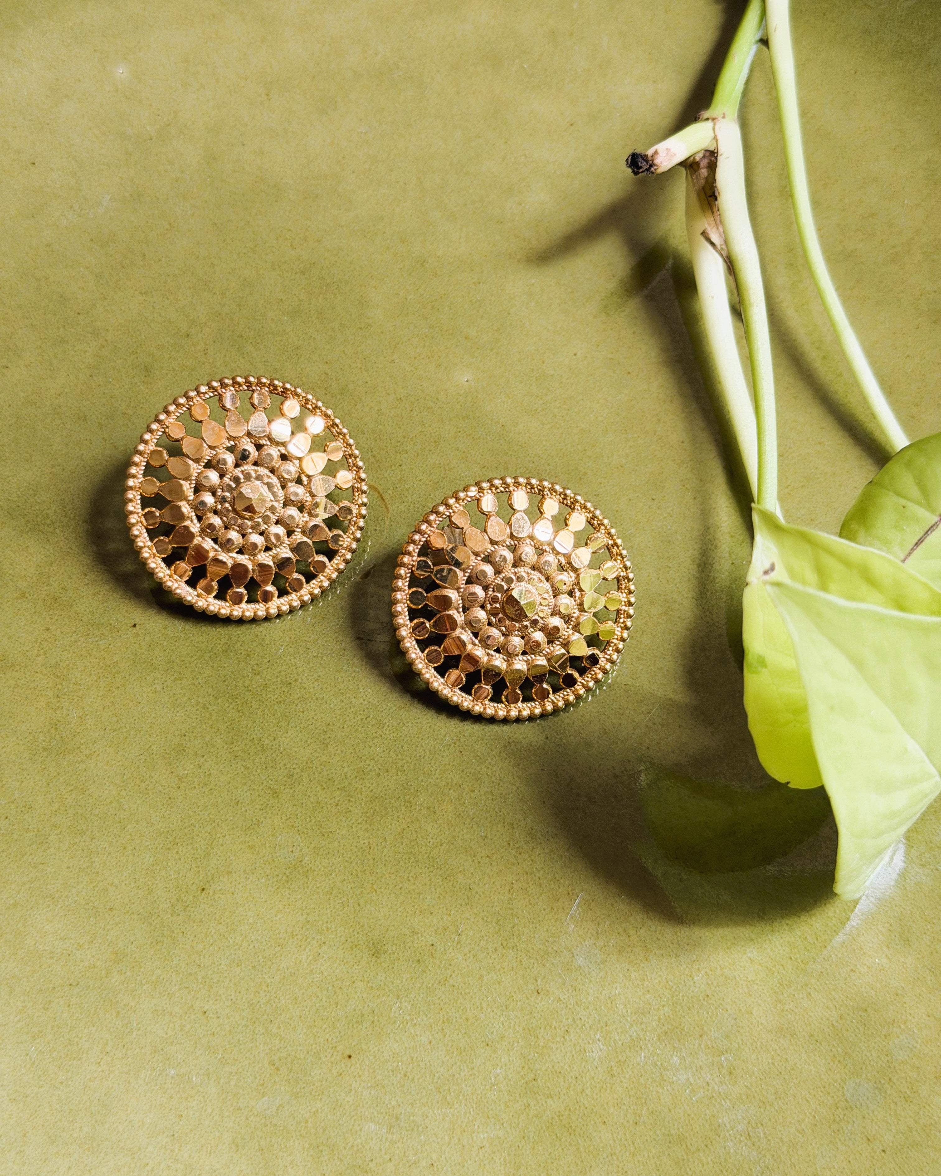 Classic round gold stud earrings with intricate handcrafted detailing