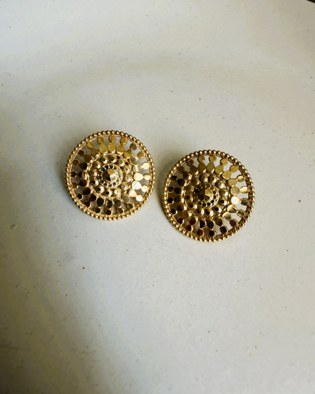 Gold floral stud earrings with intricate circular design and textured detailing